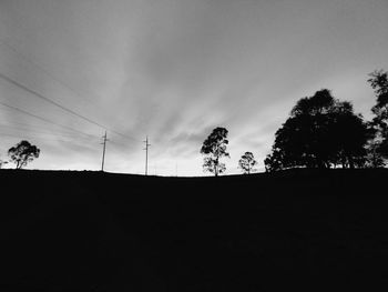 Low angle view of silhouette trees against sky