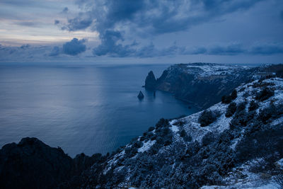 Cape fiolent crimea sevastopol. blue cloudy evening winter landscape with sea and rock.