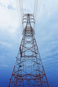 Low angle view of electricity pylon against sky