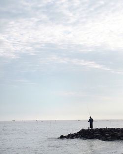 Scenic view of calm sea against cloudy sky