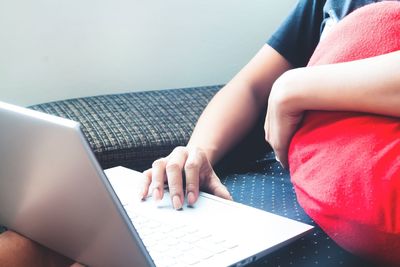 Midsection of woman using mobile phone