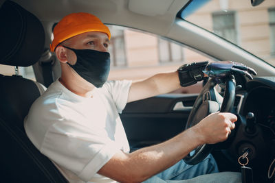 Portrait of man sitting in car