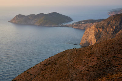 Scenic view of sea and mountains against sky