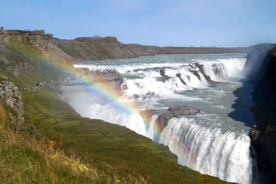 Scenic view of waterfall against sky