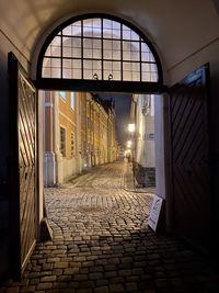 Empty street amidst buildings in city