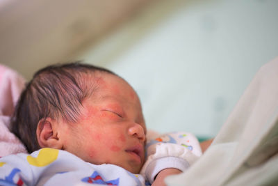 Close-up high angle view of baby boy sleeping