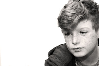 Boy with freckles against white background