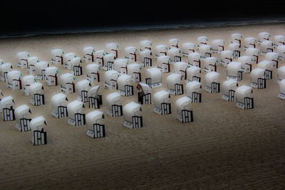 High angle view of chairs on sand
