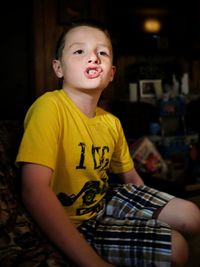 Close-up of boy sitting at home