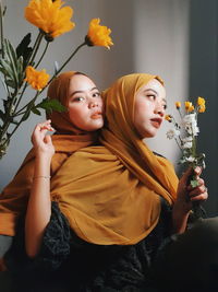 Low angle view of woman holding flower bouquet