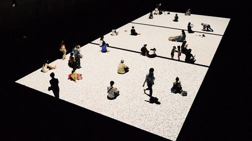 High angle view of people playing on chess
