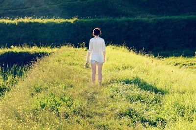 Full length of woman standing on grassy field