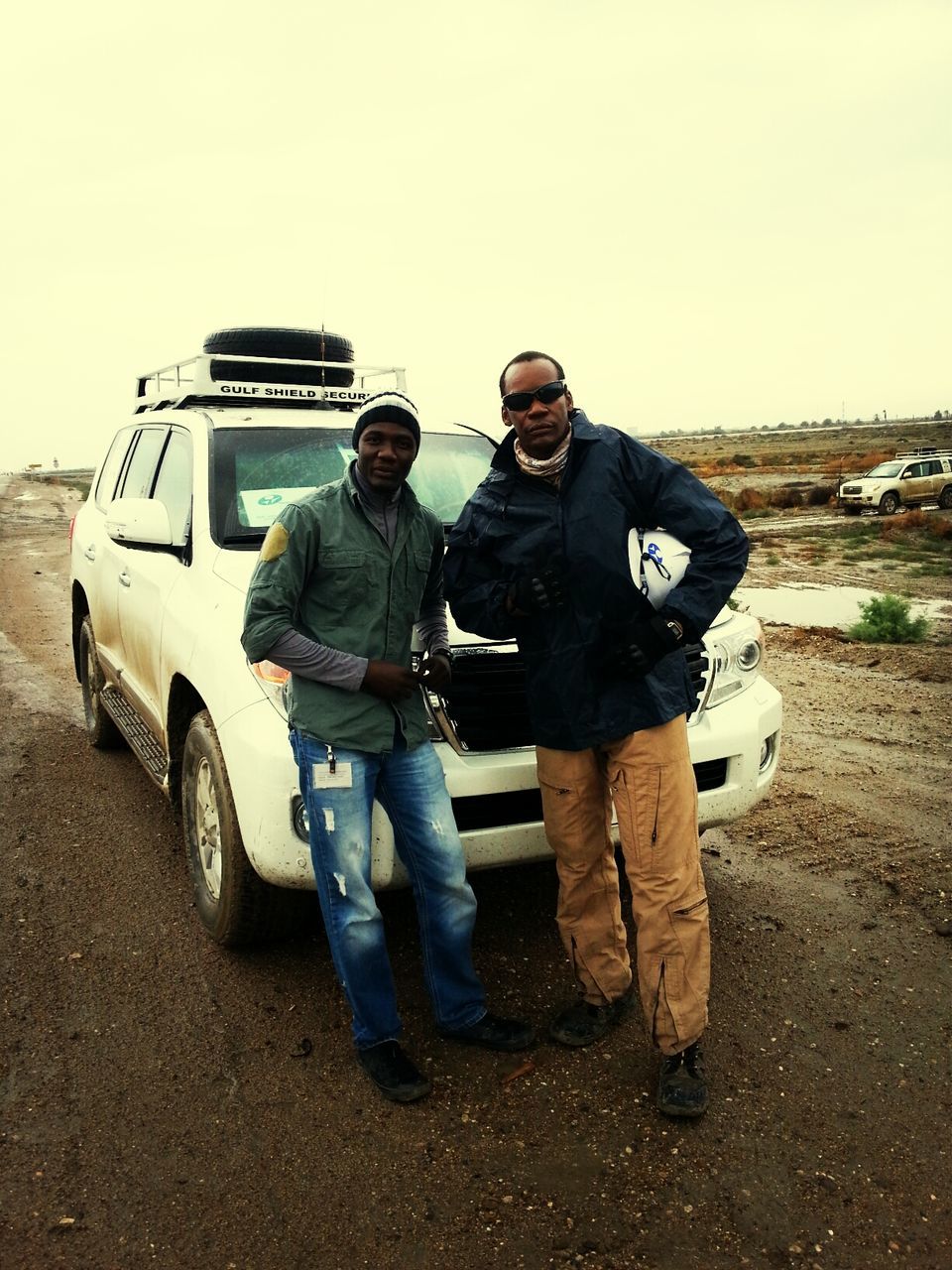 lifestyles, casual clothing, leisure activity, transportation, full length, men, clear sky, togetherness, mode of transport, young men, land vehicle, rear view, standing, copy space, day, front view, sitting