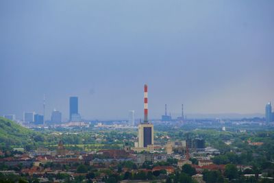 Buildings in city against clear sky