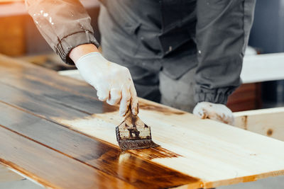 Midsection of man working on table