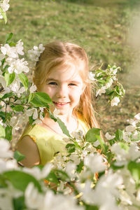 Portrait of young woman holding flowers