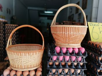 Close-up of wicker basket on egg cartons for sale at shop