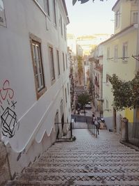 Street amidst buildings in town against sky