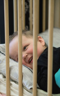 Portrait of boy lying on bed