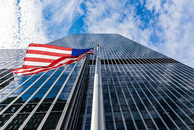 Low angle view of flag on building against sky