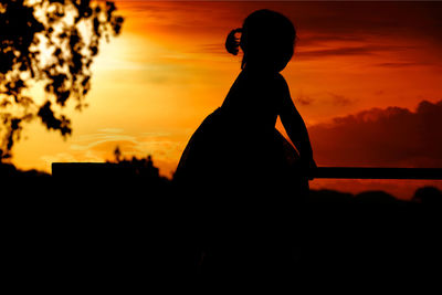Silhouette girl against scenic sky