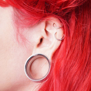 Cropped image of woman with redhead wearing earring