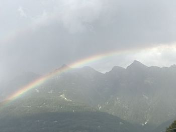 Rainbow over mountains against sky