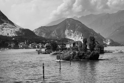 Scenic view of lake by mountains against sky