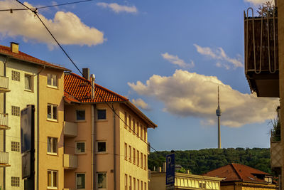 Low angle view of buildings against cloudy sky