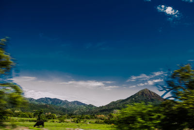 Scenic view of mountains against cloudy sky