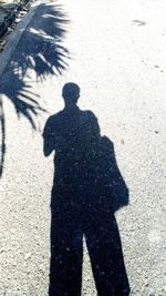 Shadow of people on street in city