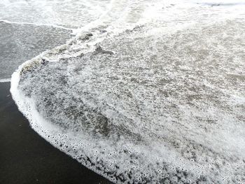 High angle view of surf on beach