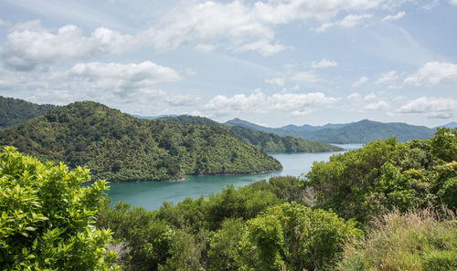 Scenic view of lake and mountains against sky