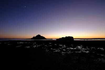 Scenic view of sea against dramatic sky during sunset