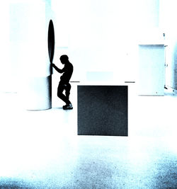 Full length of woman standing on wall