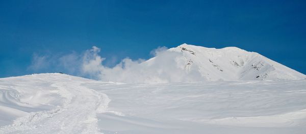 Scenic view of snowcapped mountains against sky