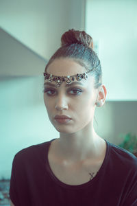 Close-up portrait of young woman wearing jewelry