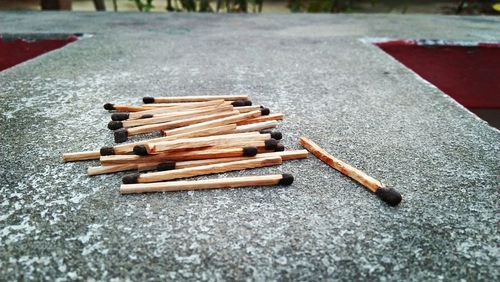 Close-up of matchsticks on retaining wall