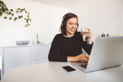 Young woman using laptop at home