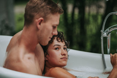 Couple in bathtub outdoors