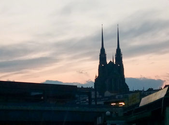 Buildings against sky during sunset in city