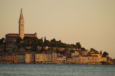 View of city by sea against clear sky