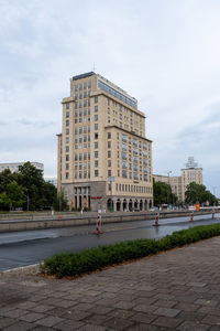 View of buildings against cloudy sky