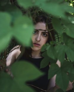Portrait of young woman with leaves