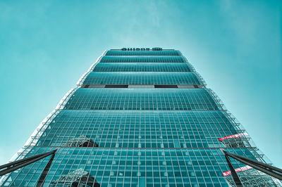 Low angle view of modern building against blue sky