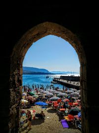 People at beach against clear sky