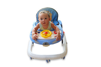 Portrait of cute boy with toy against white background