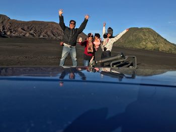 Happy family standing on ground