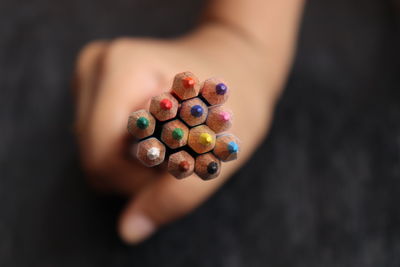 High angle view of hand holding multi colored candies