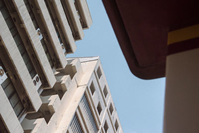 Low angle view of buildings against clear blue sky